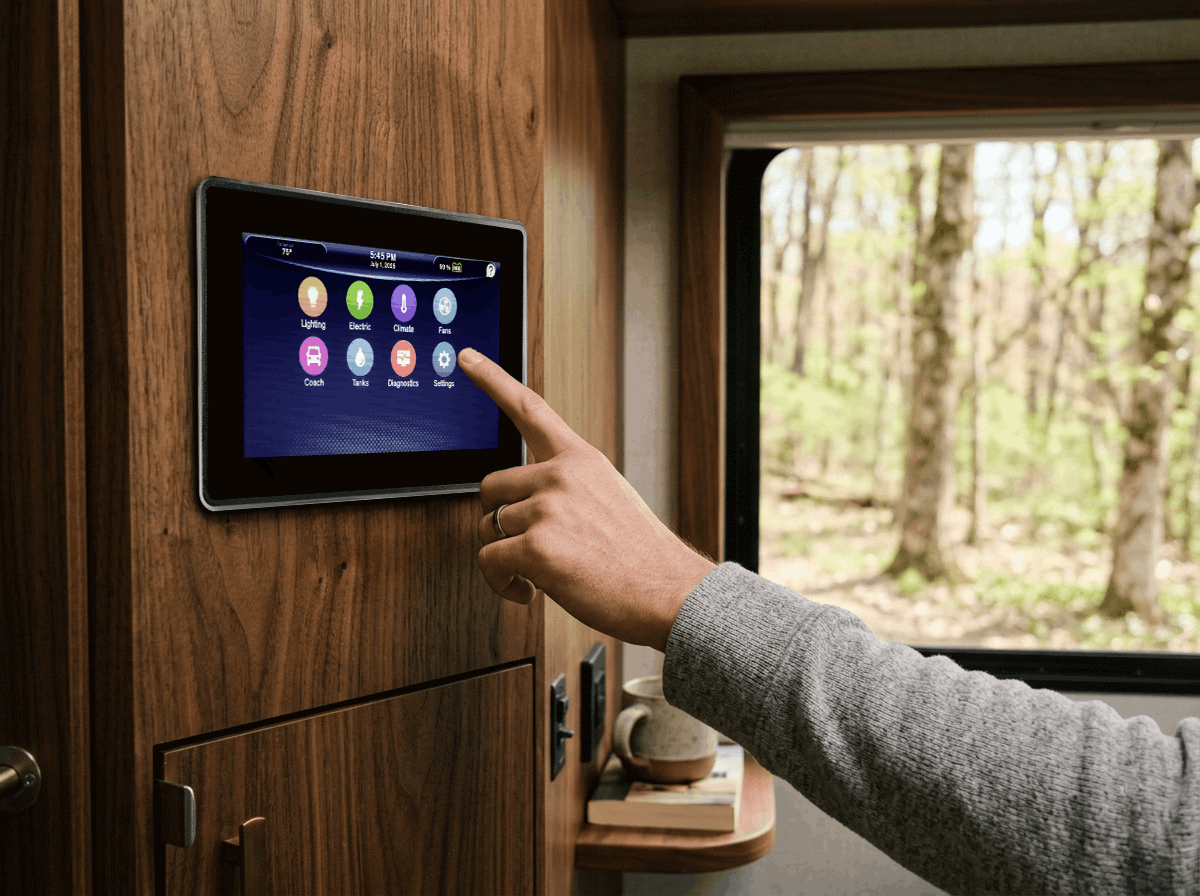 A hand pointing to the Firefly 10-inch touchscreen